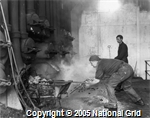 Photograph of stokers and workers in retort house at Grange-over-Sands